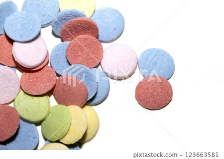 Close up of sugar paper confetti circle spots and colour dots on white background Close up of sugar paper confetti circle spots and colour dots on white background 123663581