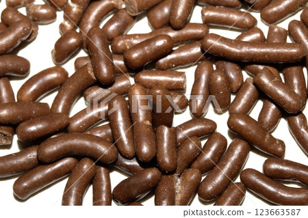 Close up of chocolate cake ice cream decoration strands sugar cocoa on white background 123663587