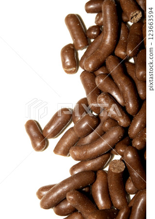Close up of chocolate cake ice cream decoration strands sugar cocoa on white background 123663594