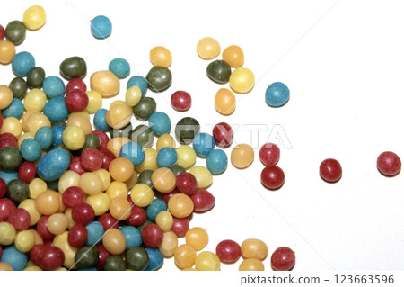 Close up of round ball sugar ice cream cake decorations on a white background 123663596