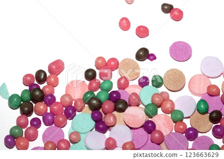 Close up of sugar paper confetti circle spots and colour dots on white background Close up of sugar paper confetti circle spots and colour dots on white background 123663629