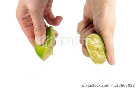 Squeezed lime isolated, squeezed out half green lemon on white background, burnout symbol 123665028