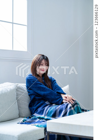 Woman relaxing in the living room in winter 123666129