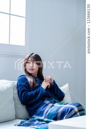 Woman relaxing in the living room in winter 123666130