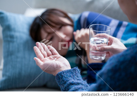 A woman who has caught a cold and is being nursed 123666140