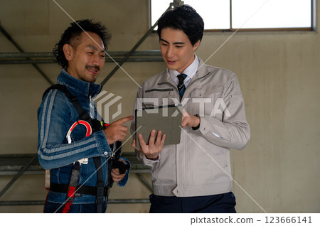 A man looking at a drawing and having a meeting A man looking at a drawing and having a meeting 123666141