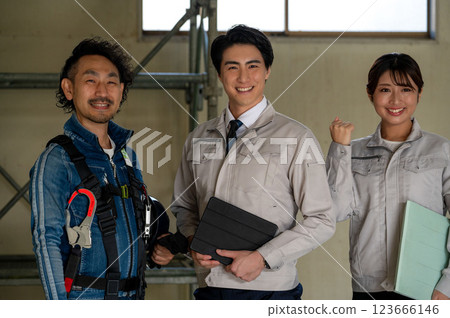 Three men and women standing side by side and making a fist pump 123666146