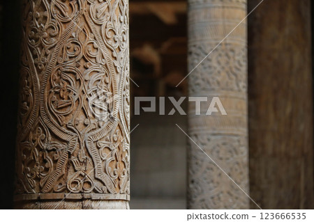 Closeup Dark Wooden Carvings on Ancient Column, detailed floral Oriental Architectural design elements. 123666535