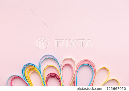 Paper strip curls on pink background 123667050
