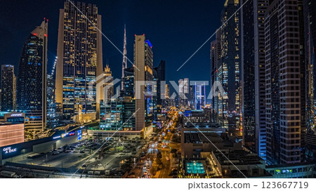 Dubai business district with modern skyscrapers, Burj Khalifa, and highrise buildings at dusk 123667719