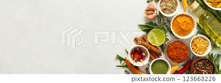 A wide selection of cooking spices and herbs on a gray background, perfect for adding depth to any dish, top view and copy space, banner A wide selection of cooking spices and herbs on a gray background, perfect for adding depth to any dish, top view and copy space, banner 123668226