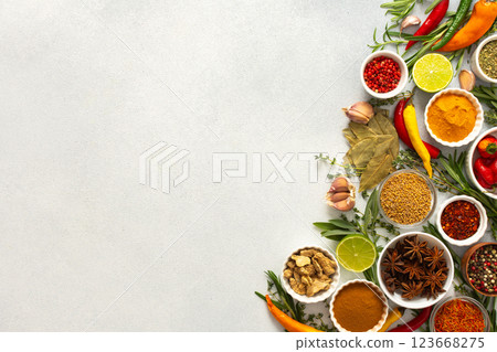 An array of culinary herbs and spices arranged on a gray background, adding aromatic accents perfect for enhancing flavor, top view and copy space An array of culinary herbs and spices arranged on a gray background, adding aromatic accents perfect for enhancing flavor, top view and copy space 123668275