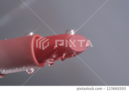 Classic lipstick with drops of water on a neutral background. Classic lipstick with drops of water on a neutral background. 123668303