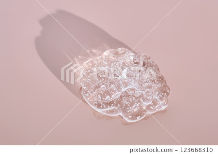 Beautiful volumetric texture of cosmetic gel on a powdery pink background. 123668310