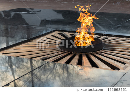 A symbolic eternal flame burning in a circular structure 123668561