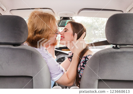 Man and woman kissing in car 123668613