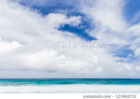 Peaceful ocean waters meet a vibrant blue sky. Mahe, Seychelles Peaceful ocean waters meet a vibrant blue sky. Mahe, Seychelles 123668722