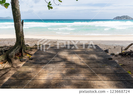 A serene tropical coastline with a wooden pathway, Seychelles A serene tropical coastline with a wooden pathway, Seychelles 123668724