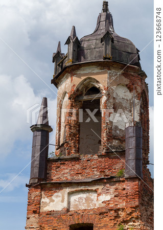 A weathered brick bell tower with gothic architectural details A weathered brick bell tower with gothic architectural details 123668748