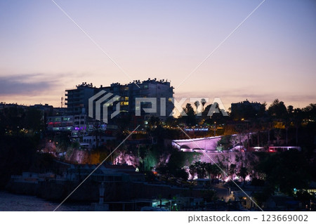 Cityscape of Antalya with illuminated buildings, cliffs, and soft sunset sky Cityscape of Antalya with illuminated buildings, cliffs, and soft sunset sky 123669002