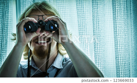 Man with binoculars spying on neighbors 123669033