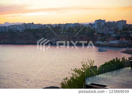 Coastal city skyline and cliffs during vibrant sunset view Coastal city skyline and cliffs during vibrant sunset view 123669039