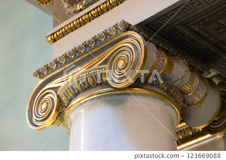 Decorative features of an Ionic column showcasing intricate gold patterns 123669088