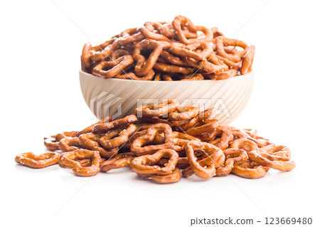 Heart shaped pretzel in bowl isolated on white background. Heart shaped pretzel in bowl isolated on white background. 123669480