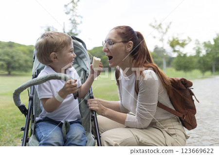 Happy family sharing food while having fun in the park 123669622