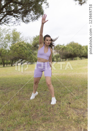 A Young Woman Engaging in a Workout Routine in a Beautiful Park on a Bright and Sunny Day A Young Woman Engaging in a Workout Routine in a Beautiful Park on a Bright and Sunny Day 123669758