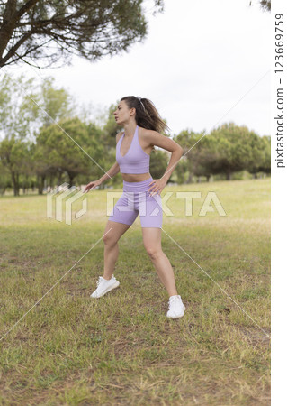 A Young Woman Energetically Engaging in Various Sports Activities at a Park on a Beautiful and Sunny Day 123669759