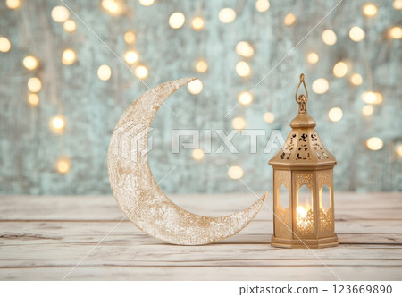 Eid celebration festive lantern and crescent moon, golden bokeh lights, background with copy space 123669890