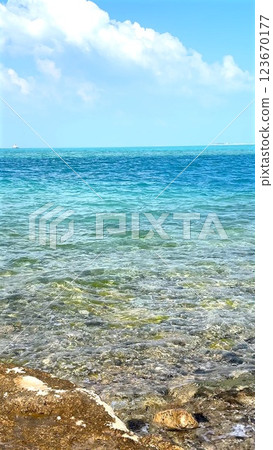 Ocean water moves across sand, shifting hues create contrast, shaping ocean ecosystem, supporting biodiversity, reflecting sky, carrying life through ocean ecosystem. Ocean water moves across sand, shifting hues create contrast, shaping ocean ecosystem, supporting biodiversity, reflecting sky, carrying life through ocean ecosystem. 123670177