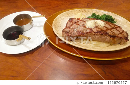 Juicy steak with two sauces at the restaurant 123670257
