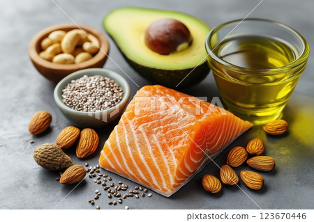 Nutrient-Rich Unsaturated Fats Selection Featuring Avocado, Nuts, Seeds, Salmon, and Olive Oil 123670446