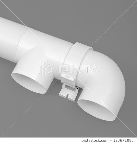 White round plastic pipe on a gray background. Ventilation system. White round plastic pipe on a gray background. Ventilation system. 123671093