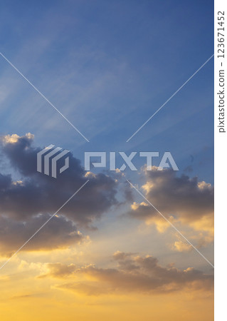 Sunbeams of sunlight breaking through the clouds in the evening with golden rays of sunshine. 123671452