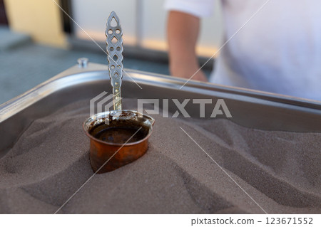 Coffee is made on the sand. Coffee is made on the street for tourists on the sand. Coffee is made on the sand. Coffee is made on the street for tourists on the sand. 123671552