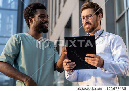 Two doctors discussing patient case and looking involved 123672486