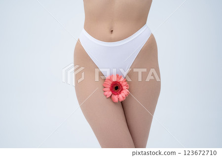 Young woman in white lingerie looking tender and vulnerable Young woman in white lingerie looking tender and vulnerable 123672710