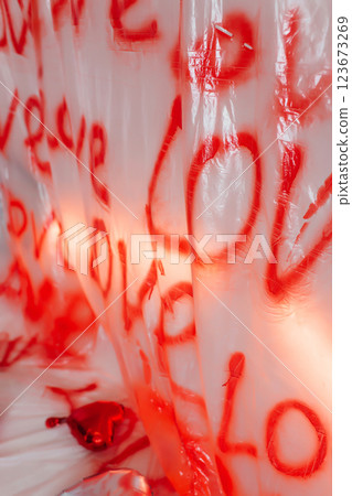 love inscription on a plastic bag with red spray paint. photo zone for March 8 123673269