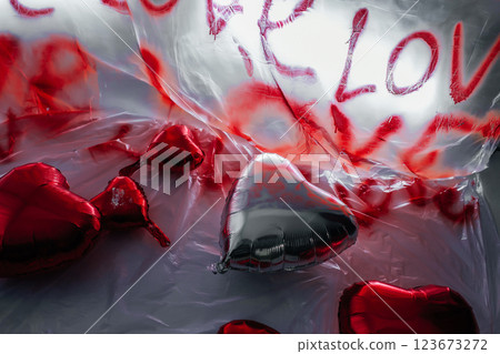 foil heart shaped balloons on white floor. photo zone for love day in photo studio 123673272