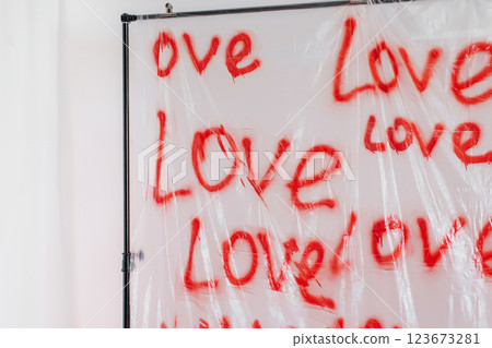 word love written on a plastic bag with an aerosol can. zone for Valentine's Day on white background 123673281