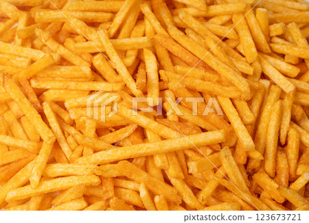Fried chips sticks texture background, finger potato ketchup flavored chips pattern, shoestring fries 123673721