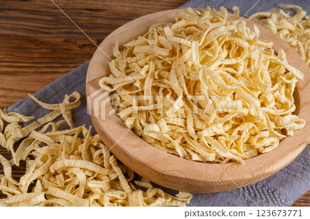 Passatelli spatzle pasta in bowl, raw spaetzle noodles, dry homemade german macaroni Passatelli spatzle pasta in bowl, raw spaetzle noodles, dry homemade german macaroni 123673771