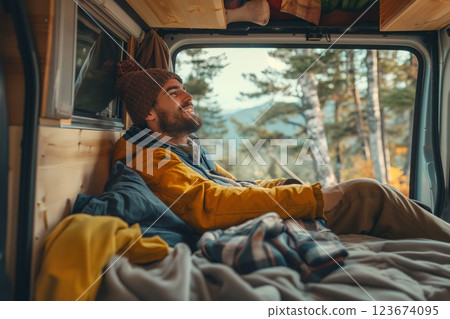Man relaxes inside a cozy camper van, taking in the forest view on a scenic road trip adventure, radiating contentment and freedom Man relaxes inside a cozy camper van, taking in the forest view on a scenic road trip adventure, radiating contentment and freedom 123674095