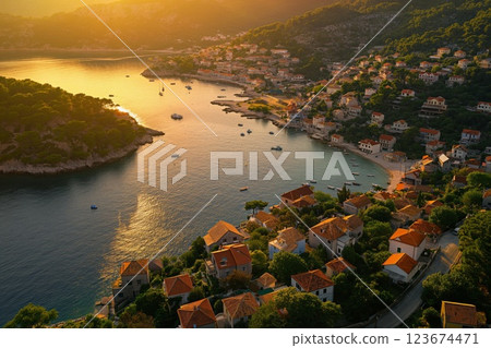 Warm sunset light bathes a picturesque mediterranean village by the sea 123674471