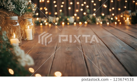 Burning candles and string lights creating warm atmosphere on wooden floor 123674538