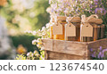 Jars of honey displayed on wooden crate with blank label tags 123674540