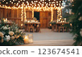 Wedding reception decorated with fairy lights and candles in rustic barn 123674541
